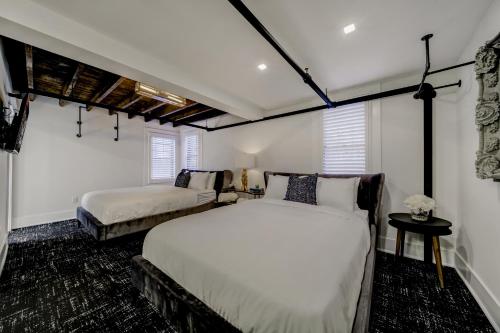 a bedroom with two beds and two windows at The Westlake in Toronto