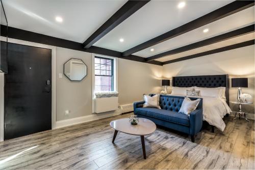 a bedroom with a bed and a blue couch at The Westlake in Toronto