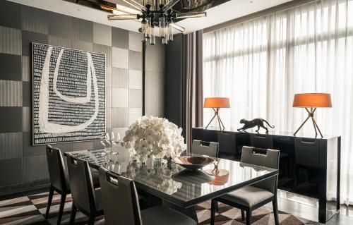 a dining room with a black table and chairs at Four Seasons Hotel Kuala Lumpur in Kuala Lumpur