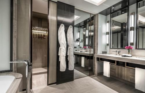 a bathroom with two sinks and two mirrors at Four Seasons Hotel Kuala Lumpur in Kuala Lumpur