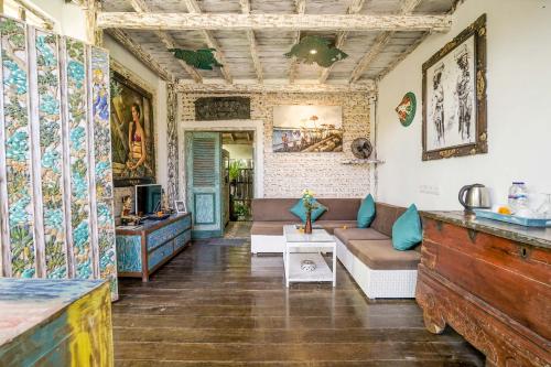 a living room with a couch and a table at KTS Balinese Villas in Canggu