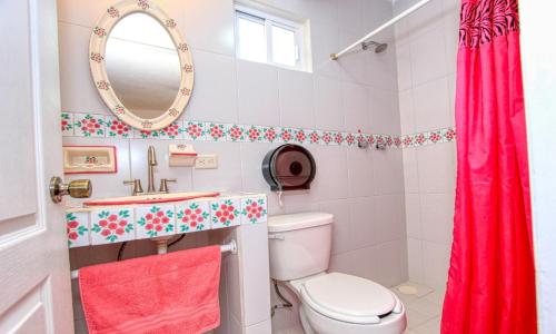 a bathroom with a toilet and a sink and a mirror at Hotel Spa Maggic Home Panorámica in Guanajuato