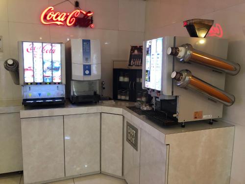 a coffee shop with two monitors on a counter at Restay Mito (Adult Only) in Mito