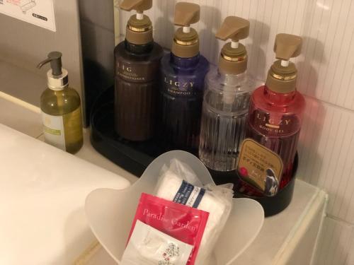 a counter with four bottles of soap and a heart shapedvisor at Restay Mito (Adult Only) in Mito
