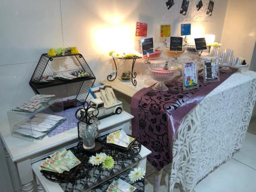 a store with a purple and white table with flowers at Restay Mito (Adult Only) in Mito
