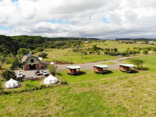 an aerial view of a farm with tents in a field at The Inn at Kulaniapia Falls in Hilo