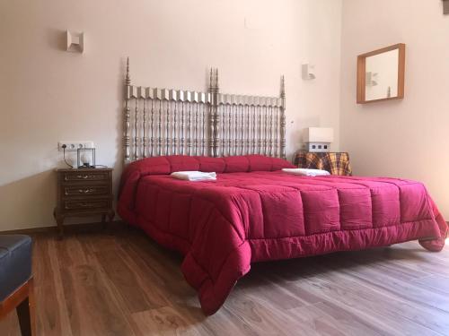 a bedroom with a large bed with a red blanket at la Pepi house 2 in Arcones