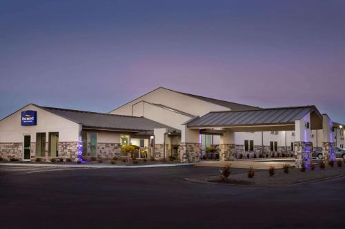 a hotel front of a building with a parking lot at Baymont Inn & Suites Shawnee in Shawnee