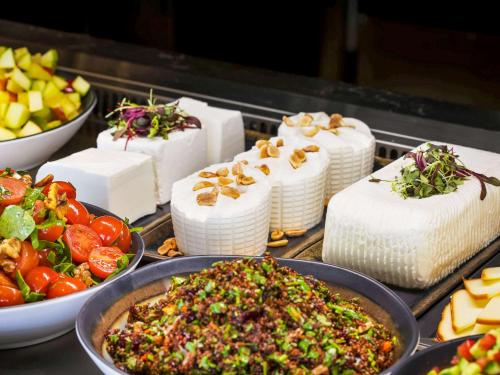 a group of cakes and other food on a table at Ibis Styles Jerusalem City Center - An AccorHotels Brand in Jerusalem