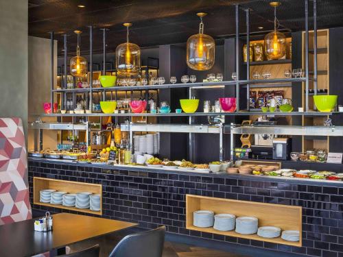 a restaurant with a counter with plates of food at Ibis Styles Jerusalem City Center - An AccorHotels Brand in Jerusalem