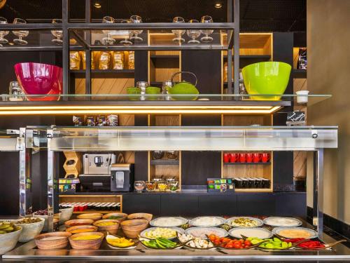 a kitchen with many different types of food on display at Ibis Styles Jerusalem City Center - An AccorHotels Brand in Jerusalem