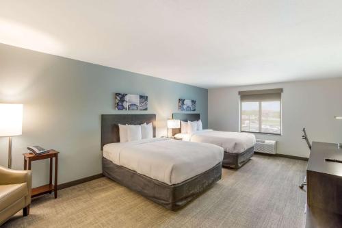 a hotel room with two beds and a window at MainStay Suites Logan Ohio-Hocking Hills in Logan