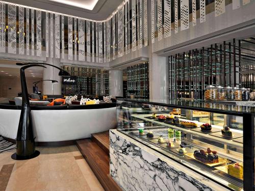 a restaurant with a buffet of food on display at Pullman Kuala Lumpur City Centre Hotel & Residences in Kuala Lumpur