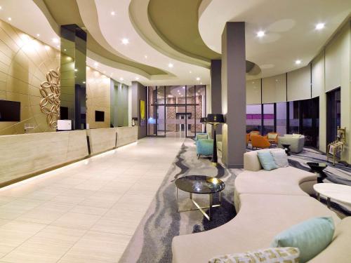 a lobby of a hotel with couches and chairs at Mercure Selangor Selayang in Batu Caves