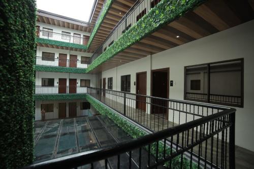 an external view of a building with green ivy at SureStay Plus Hotel by Best Western AC LUXE Angeles City in Angeles