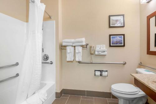 a bathroom with a toilet and a shower at Comfort Inn Medford North in Medford