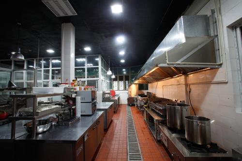 a large kitchen with lots of counters and appliances at Aoting Garden Hotel in Chengdu