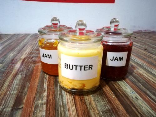 three jars of jam sitting on a wooden table at QuiikCat in Kuching