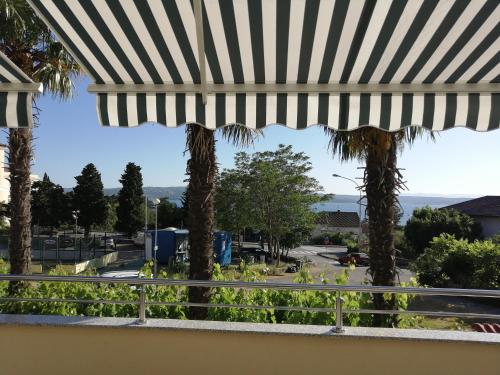 a view from the balcony of a resort with palm trees at Romantic New Superior Apartment Palma about 150m to Sandy beach in Crikvenica