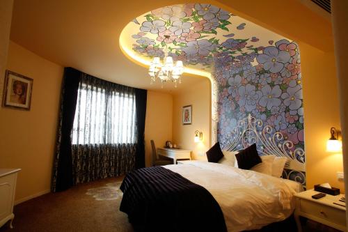 a bedroom with a large flower mural on the wall at Aoting Garden Hotel in Chengdu