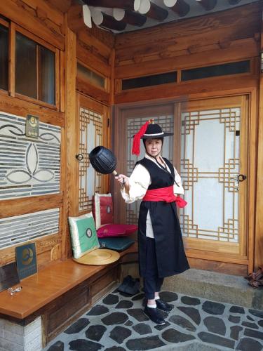 a woman standing in a room in a wooden room at Dajayon Hanok Stay in Seoul