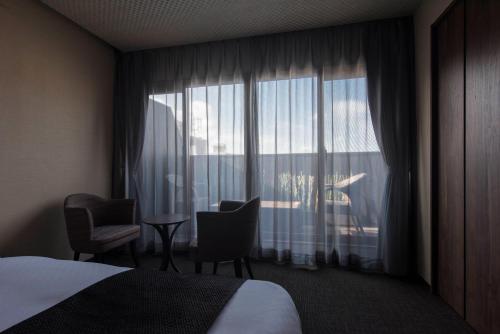 a hotel room with a bed and a large window at Hotel ZIZI Kyoto Gion in Kyoto
