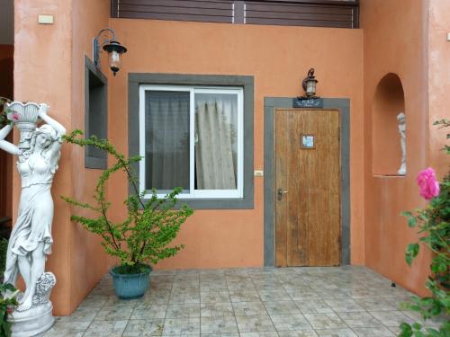 a statue of a woman standing outside of a house at Bramasole B&B in Puli