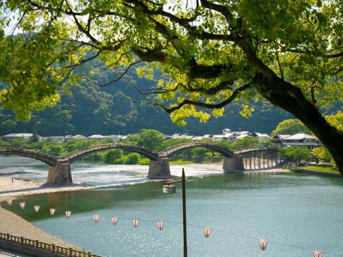 a bridge over a river with a body of water at Iwakuni Kokusai Kanko Hotel in Iwakuni