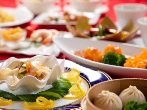 a table full of plates of food with dumplings at Iwakuni Kokusai Kanko Hotel in Iwakuni