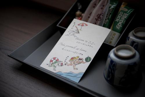 a invitation to a party with a dog on a table at Hotel ZIZI Kyoto Gion in Kyoto