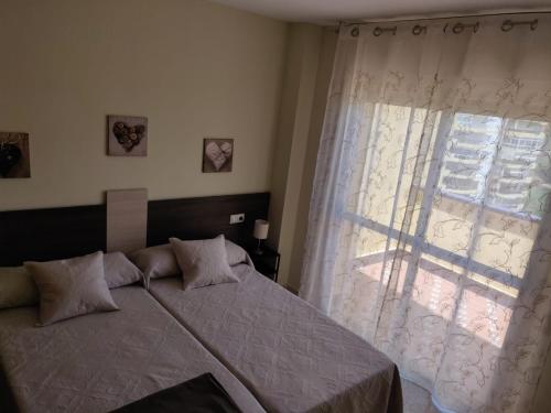 Postel nebo postele na pokoji v ubytování ÁTICO VISTAMAR penthouse with views