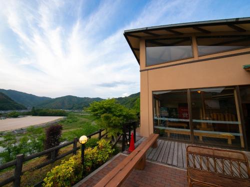 a building with a balcony with a view of a valley at Iwakuni Kokusai Kanko Hotel in Iwakuni