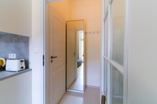 a hallway with a mirror next to a door at Bouquet Apartments in Prague