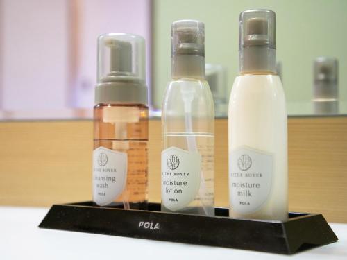 three bottles of moisturizers sitting on a shelf at Iwakuni Kokusai Kanko Hotel in Iwakuni