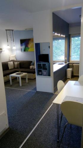 a living room with a couch and a room with a living room at Art Apartman in Plitvička Jezera