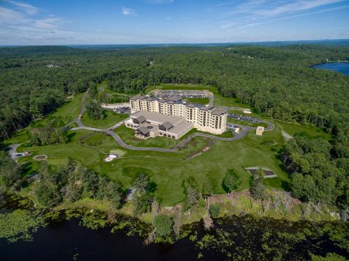 an aerial view of a resort on a island in the water at YO1 Longevity & Health Resorts, Catskills in Monticello