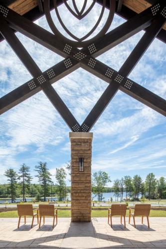 a group of chairs in a pavilion with a brick pillar at YO1 Longevity & Health Resorts, Catskills in Monticello