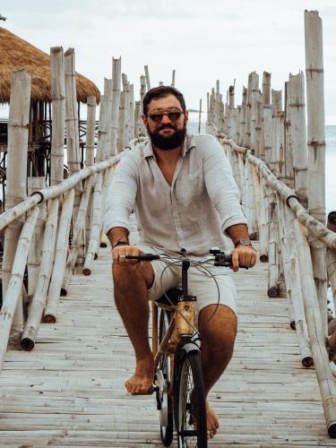 a man riding a bike on a bridge at North Zen Villas in Panglao