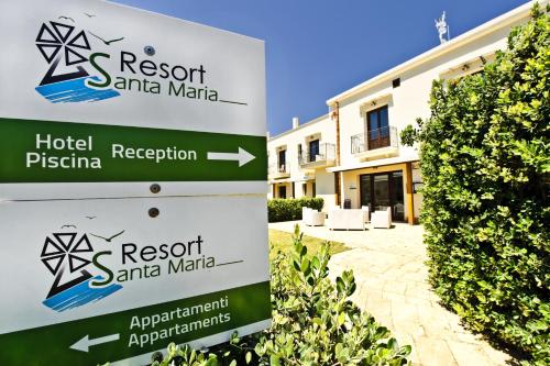 a sign for a hotel in front of a building at Resort Santa Maria Hotel in Birgi Vecchi