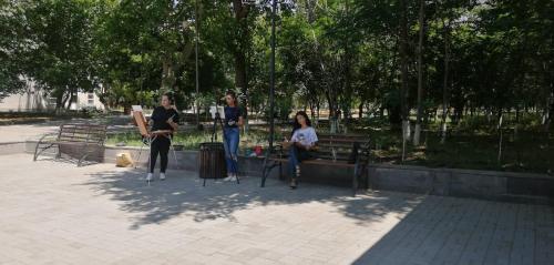 a group of people sitting on a bench in a park at HOTEL N1 in Yerevan