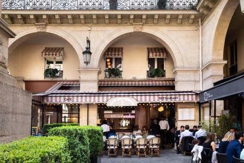 a group of people sitting outside of a building at Hôtel de la Tour Eiffel in Paris