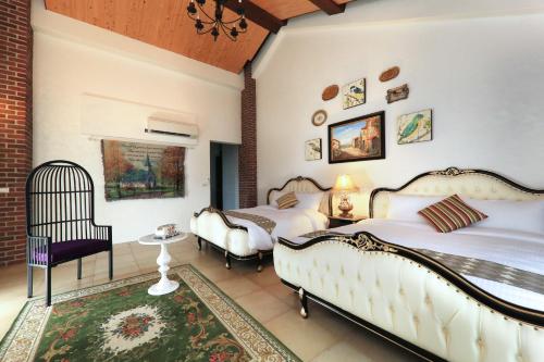 a bedroom with two beds and a chair in it at Black Chimney in Datong
