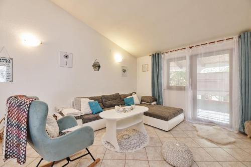 a living room with a couch and a table and chairs at Villa Amelie in Kaštelir