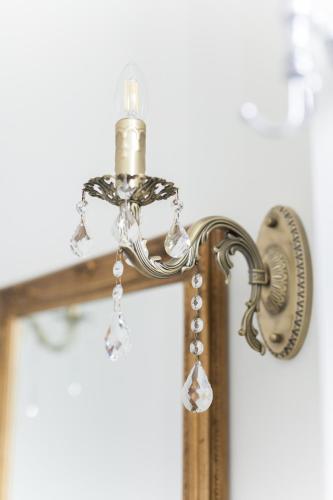 a mirror with a light on top of a cross at Alessia's Place in Como