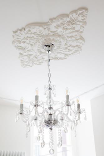 a chandelier hanging from a ceiling in a room at Alessia's Place in Como
