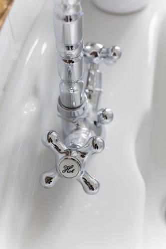 a bathroom sink with a chrome faucet at Alessia's Place in Como