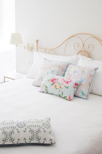 a white bed with two pillows on it at Alessia's Place in Como