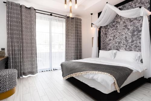 a bedroom with a canopy bed and a large window at Hotel Karbel Sun in Oludeniz