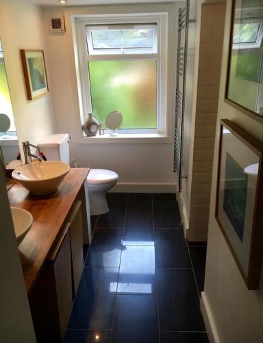 a bathroom with two sinks and a window at Lovely New York style flat in Greenwich - Blackheath in London