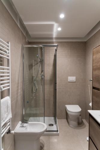 a bathroom with a shower and a toilet and a sink at Me&Sea B&B in San Nicola Arcella